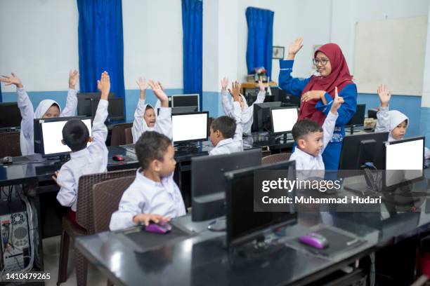 students raise their hands - asian-students-classroom-computer stock pictures, royalty-free photos & images
