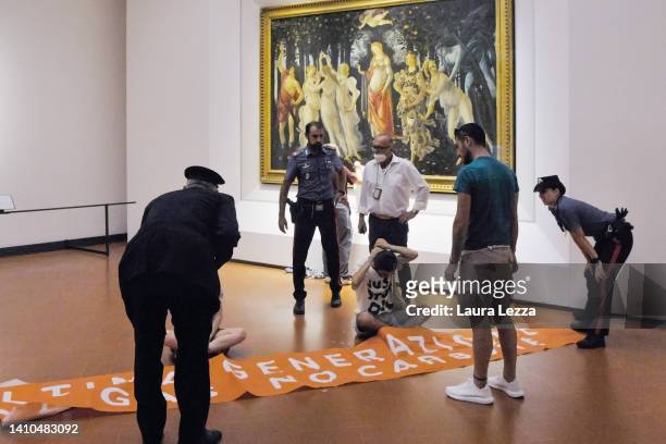 The Carabinieri police arrive after Activists from the action group Ultima Generazione glue their hands to the glass covering Sandro Botticelli's La...