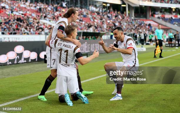 Johannes Eggestein of FC St. Pauli celebrates with Jackson Irvine and Manolis Saliakas after he sores the opening goal during the Second Bundesliga...