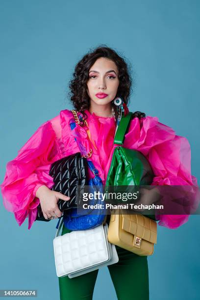 woman with many purses - handtasche stock-fotos und bilder