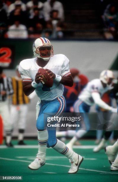 Quarterback Warren Moon of the Houston Oilers looks to pass the ball in the game against the New York Jets during the Houston Oilers vs New York Jets...