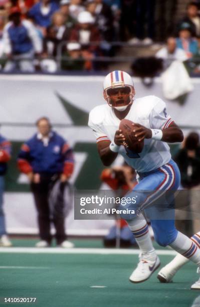 Quarterback Warren Moon of the Houston Oilers looks to pass the ball in the game against the New York Jets during the Houston Oilers vs New York Jets...