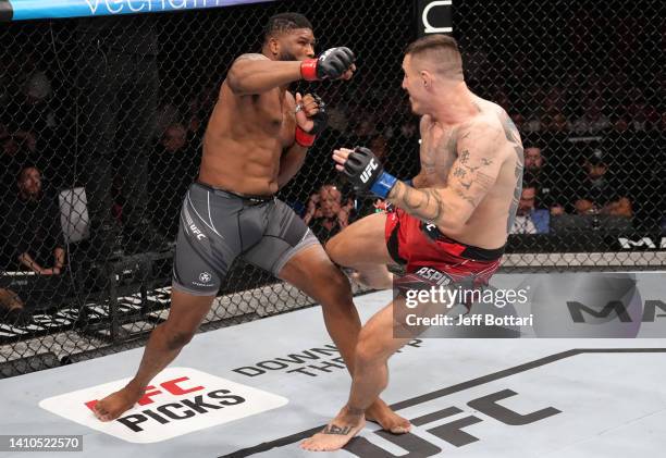 Curtis Blaydes and Tom Aspinall of England trade strikes in a heavyweight fight during the UFC Fight Night event at O2 Arena on July 23, 2022 in...