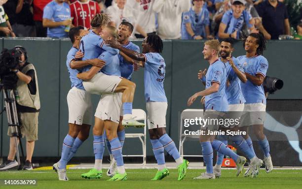 Erling Haaland of Manchester City celebrates with Jack Grealish and teammates after scoring their team's first goal during the pre-season friendly...