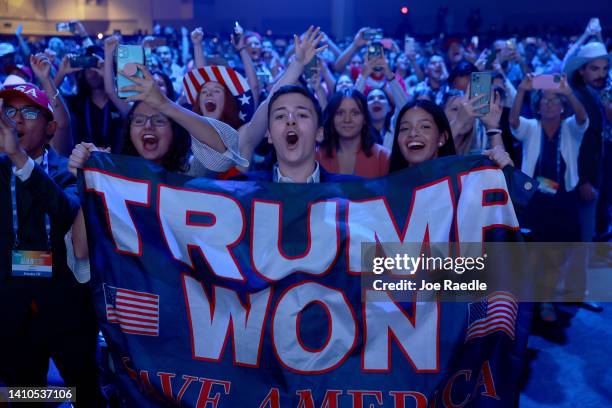 People cheer as former U.S. President Donald Trump arrives on stage during the Turning Point USA Student Action Summit held at the Tampa Convention...