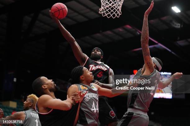 Earl Clark of the Trilogy elevates for the layup over Elijah Stewart and Isaiah Austin of the Enemies during BIG3 Week Six at Comerica Center on July...