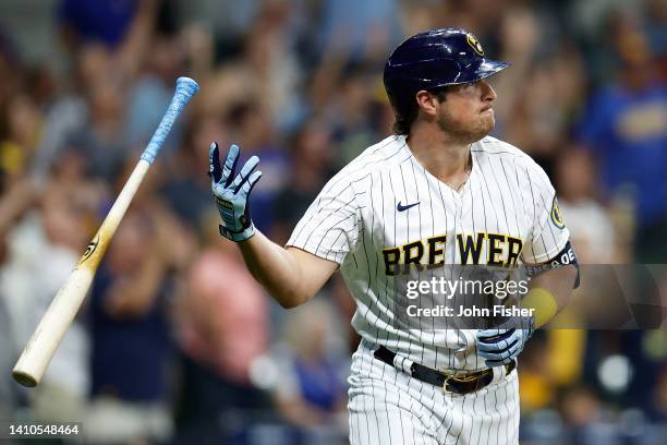 Hunter Renfroe of the Milwaukee Brewers flips his bat into the air after hitting a three run homer in the fourth inning against the Colorado Rockies...