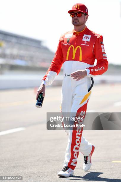 Kurt Busch, driver of the McDonald's Toyota, walks the grid during qualifying for the NASCAR Cup Series M&M's Fan Appreciation 400 at Pocono Raceway...