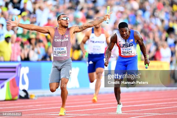 Andre de Grasse of Team Canada and Marvin Bracy of Team United States cross the finish line of the Men's 4x100m Relay Final on day nine of the World...