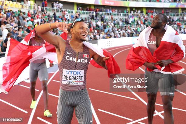 Aaron Brown, Andre de Grasse, and Brendon Rodney of Team Canada celebrate winning gold in the Men's 4x100m Relay Final on day nine of the World...