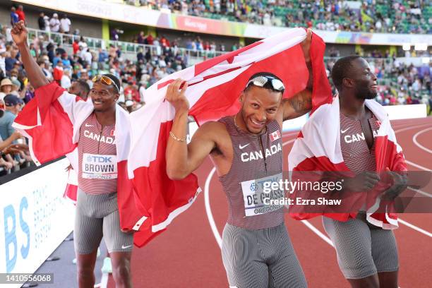 Aaron Brown, Andre de Grasse, and Brendon Rodney of Team Canada celebrate winning gold in the Men's 4x100m Relay Final on day nine of the World...