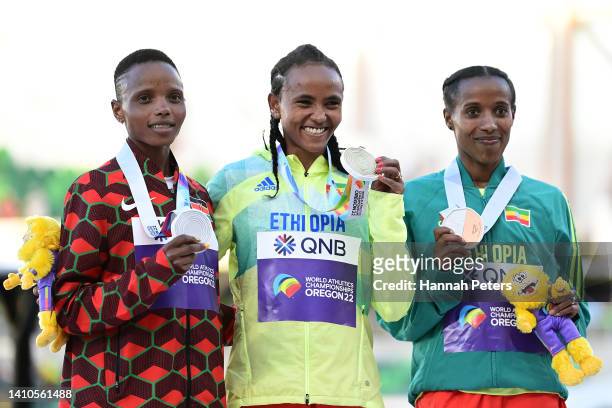 Silver medalist Beatrice Chebet of Team Kenya, gold medalist Gudaf Tsegay of Team Ethiopia, and bronze medalist Dawit Seyaum of Team Ethiopia pose...