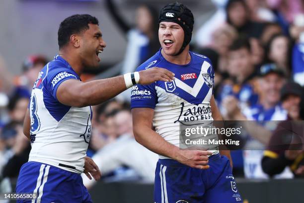 Matt Burton of the Bulldogs celebrates with team mates after scoring a try during the round 19 NRL match between the Canterbury Bulldogs and the Gold...