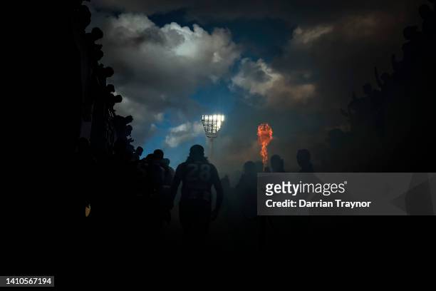 Collingwood players run out before the round 19 AFL match between the Collingwood Magpies and the Essendon Bombers at Melbourne Cricket Ground on...