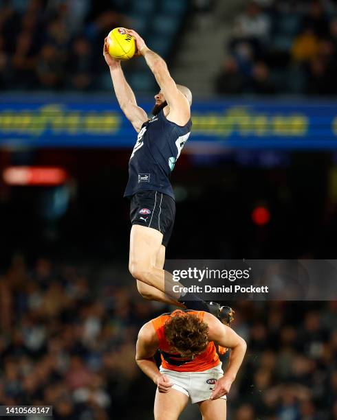 Adam Saad of the Blues takes a high mark over James Peatling of the Giants during the round 19 AFL match between the Carlton Blues and the Greater...