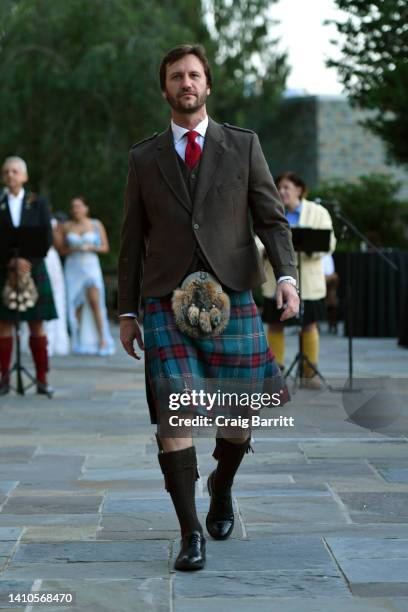 Model walks the runway at the Dressed To Kilt Fashion Show and Charity Dinner At Millneck Manor on July 23, 2022 in Mill Neck, New York.