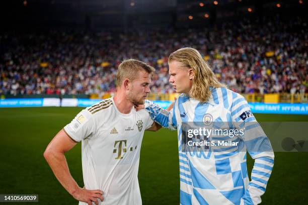 Matthijs de Ligt FC Bayern Muenchen and Erling Haaland of Manchester City embrace after the pre-season friendly match between Bayern Munich and...