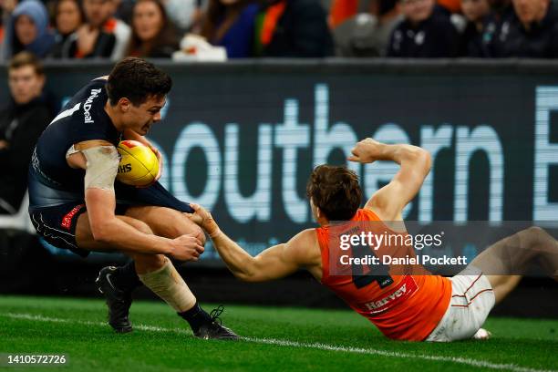 Jack Silvagni of the Blues is tackled by Toby Greene of the Giants during the round 19 AFL match between the Carlton Blues and the Greater Western...