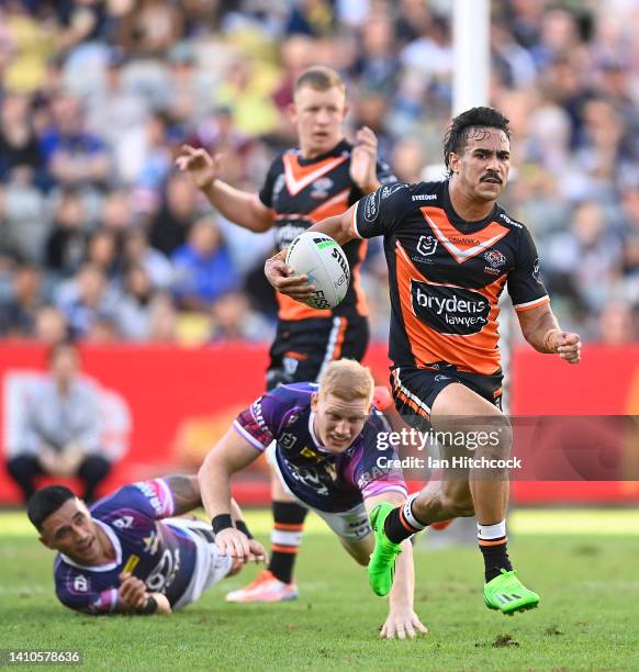 Daine Laurie of the Tigers makes a break during the round 19 NRL match between the North Queensland Cowboys and the Wests Tigers at Qld Country Bank...