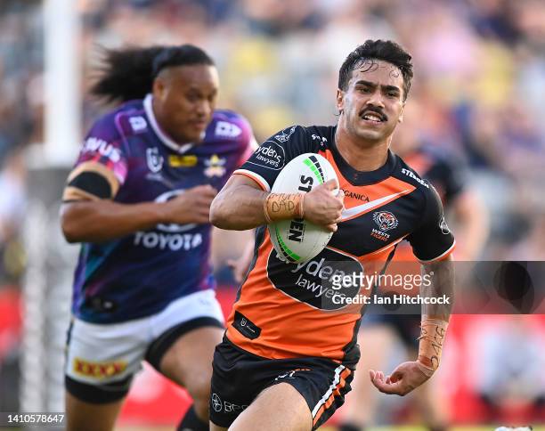 Daine Laurie of the Tigers makes a break during the round 19 NRL match between the North Queensland Cowboys and the Wests Tigers at Qld Country Bank...