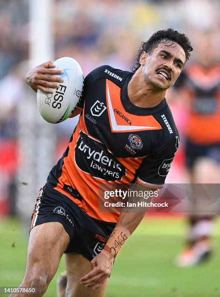 Daine Laurie of the Tigers makes a break during the round 19 NRL match between the North Queensland Cowboys and the Wests Tigers at Qld Country Bank...