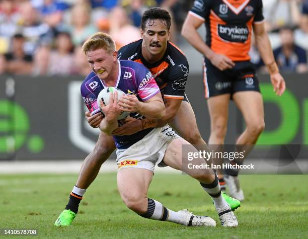 Tom Dearden of the Cowboys is tackled by Daine Laurie of the Tigers during the round 19 NRL match between the North Queensland Cowboys and the Wests...