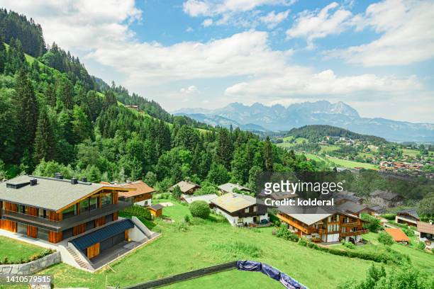 tyrol pastoral villages with traditional chalet buildings, picturesque summer landscape of european alps - kitzbuehel stock pictures, royalty-free photos & images