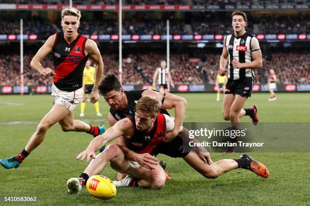 Scott Pendlebury of the Magpies tackles Ben Hobbs of the Bombers during the round 19 AFL match between the Collingwood Magpies and the Essendon...