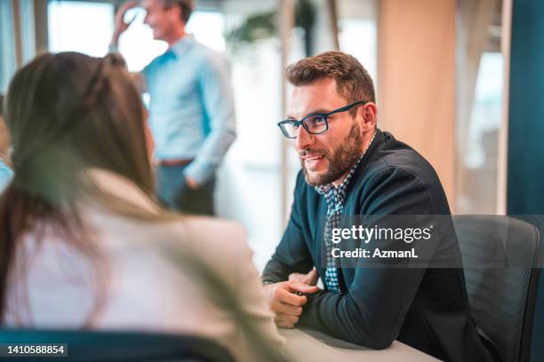 young male lawyer in a business meeting with a female client - advocate stock pictures, royalty-free photos & images