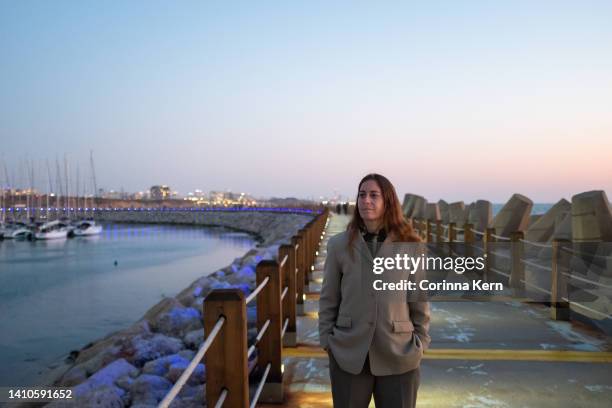 woman standing on pier near seaside - israel nature stock pictures, royalty-free photos & images