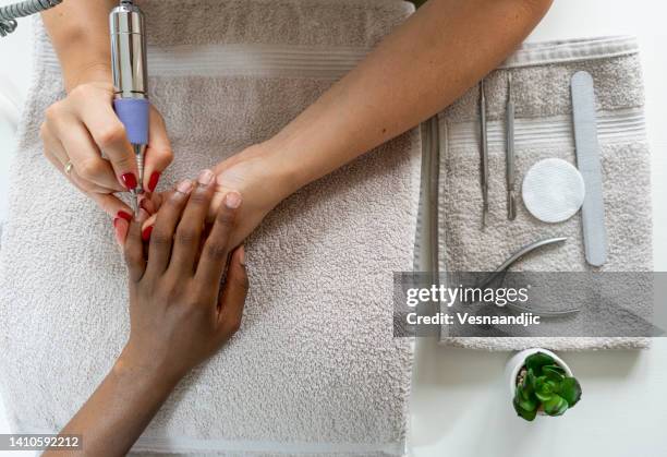 close up of female hands having manicure treatment - african american nails stock pictures, royalty-free photos & images