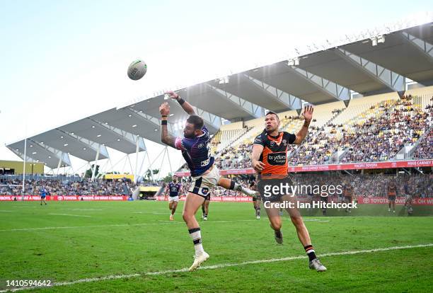 Kyle Feldt of the Cowboys and Brent Naden of the Tigers contest the ball during the round 19 NRL match between the North Queensland Cowboys and the...