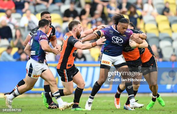 Luciano Leilua of the Cowboys is tackled during the round 19 NRL match between the North Queensland Cowboys and the Wests Tigers at Qld Country Bank...