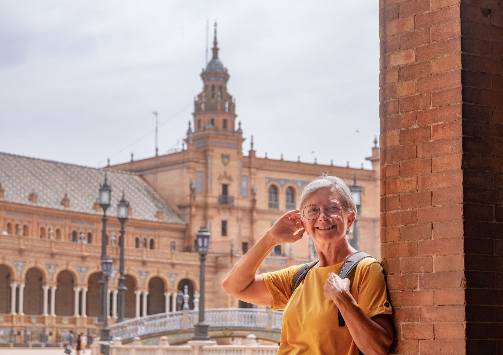 Happy senior woman traveling in Seville, Spain visiting famous places - attractive elderly traveler enjoying summer and cultural vacation Happy senior woman traveling in Seville, Spain visiting famous places - attractive elderly traveler enjoying summer and cultural vacation