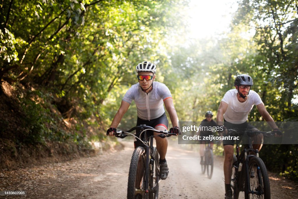Group of mountainbikers riders , biking outdoor up mountain