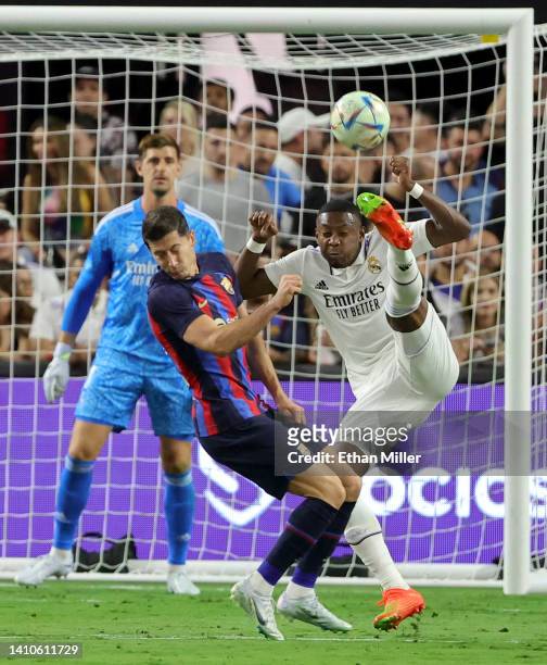 Robert Lewandowski of Barcelona runs into David Alaba of Real Madrid as he tries to clear the ball during their preseason friendly match at Allegiant...