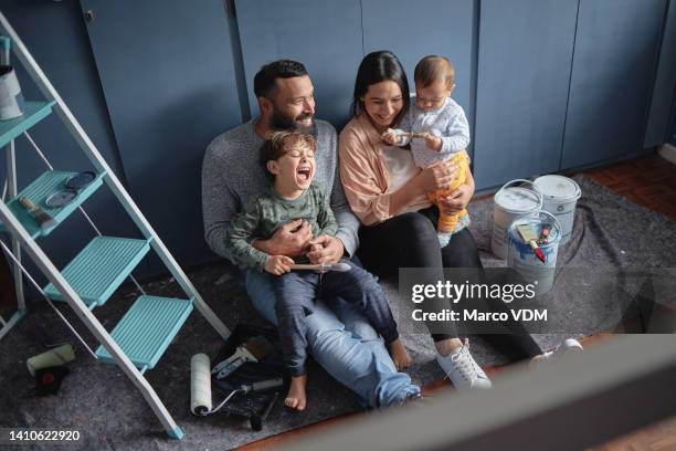 fun family renovating diy home improvements and painting new property together. above view of mother, father and children bonding. having fun, laughing, redecorating, designing purchased real estate - before and after stock pictures, royalty-free photos & images