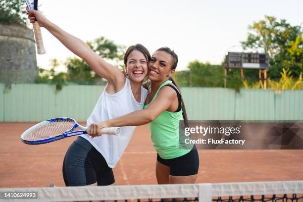 portrait of caucasian female tennis players celebrate the win at the doubles - form fitted stock pictures, royalty-free photos & images