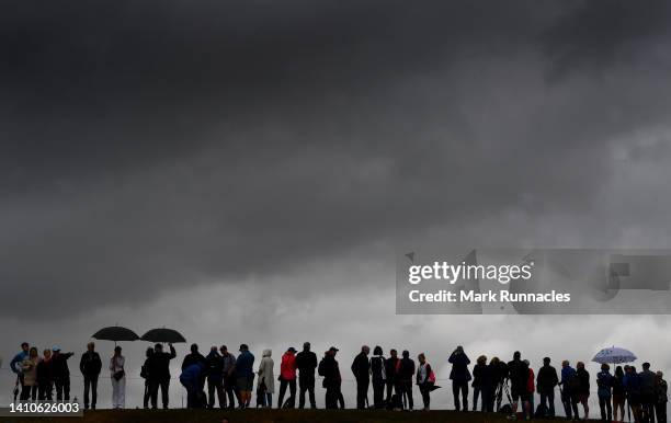 Golf fans line up at the first green as wet weather moves in for the final round of The Senior Open Presented by Rolex at The King's Course at...