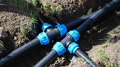 Connecting HDPE plastic water pipes in garden closeup