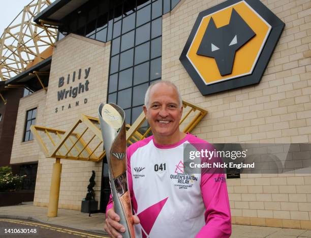 Batonbearer Steve Bull holds the Queen's Baton during the Birmingham 2022 Queen's Baton Relay visit to Wolverhampton Wanderers F.C. On July 24...