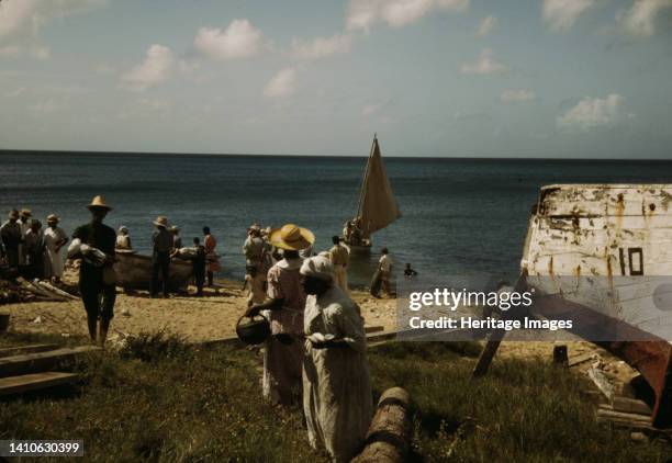 Housewives at the seashore waiting for the fishing boats to come in Frederiksted, Saint Croix, Virgin Islands. Artist Jack Delano.