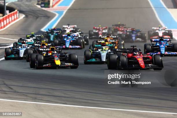 Charles Leclerc of Monaco driving the Ferrari F1-75 leads Max Verstappen of the Netherlands driving the Oracle Red Bull Racing RB18 and the rest of...