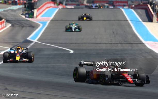 Charles Leclerc of Monaco driving the Ferrari F1-75 leads Max Verstappen of the Netherlands driving the Oracle Red Bull Racing RB18 during the F1...