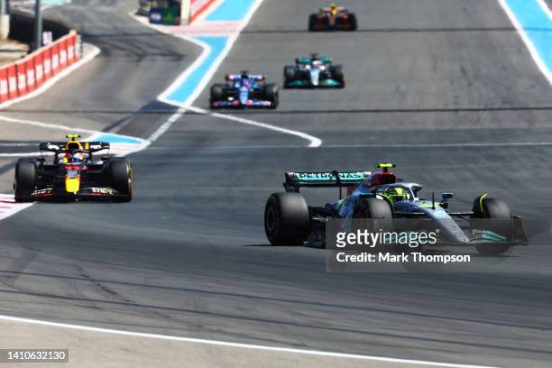 Lewis Hamilton of Great Britain driving the Mercedes AMG Petronas F1 Team W13 leads Sergio Perez of Mexico driving the Oracle Red Bull Racing RB18...
