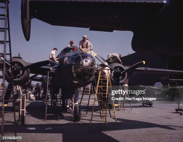 Employees on the "Sunshine" assembly line at North American's plant put the finishing touches on another B-25 bomber, Inglewood, Calif. In addition...