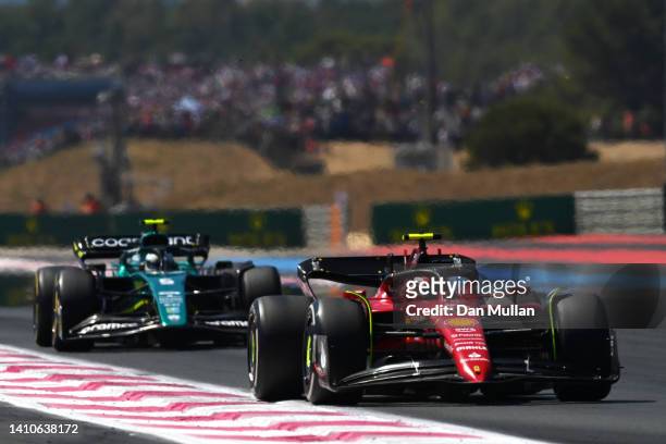 Carlos Sainz of Spain driving the Ferrari F1-75 leads Sebastian Vettel of Germany driving the Aston Martin AMR22 Mercedes during the F1 Grand Prix of...