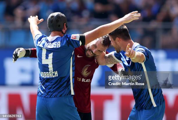 Markus Kolke , goalkeeper of Hansa Rostock celebrate victory with team mate Ryan Malone and Damian Rossbach after the Second Bundesliga match between...