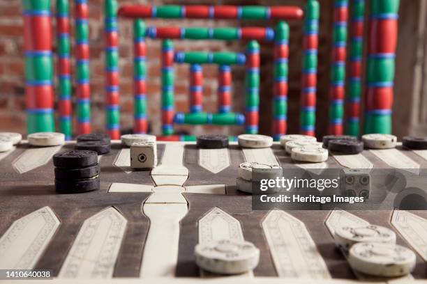 Dover Castle, Dover, Kent, . Detail of a gaming board on a table in room F14 of Dover Castle's Great Tower, with a colourful chair back behind....