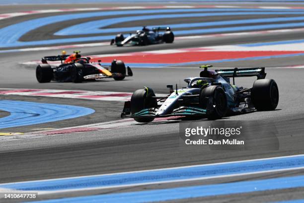 Lewis Hamilton of Great Britain driving the Mercedes AMG Petronas F1 Team W13 leads Sergio Perez of Mexico driving the Oracle Red Bull Racing RB18...